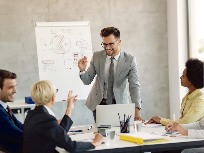 young-businessman-communicating-with-his-colleagues-meeting-office_637285-9201